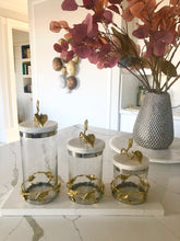 Load image into Gallery viewer, Gold and Glass Canister With Leaf Design And Marble Lid
